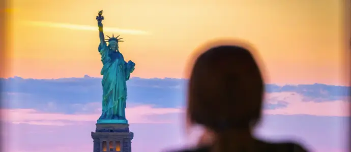 Woman looks out at the Statue of Liberty